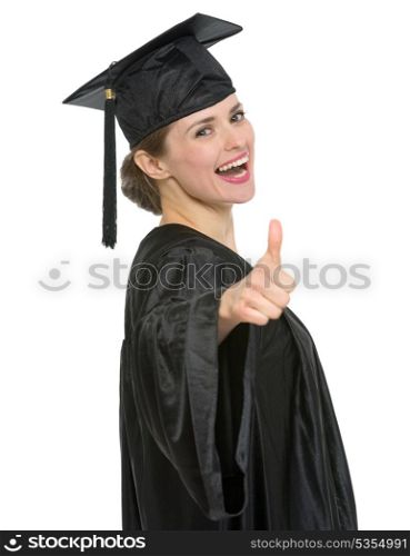 Smiling graduation student woman showing thumbs up. HQ photo. Not oversharpened. Not oversaturated. Smiling graduation student woman showing thumbs up isolated