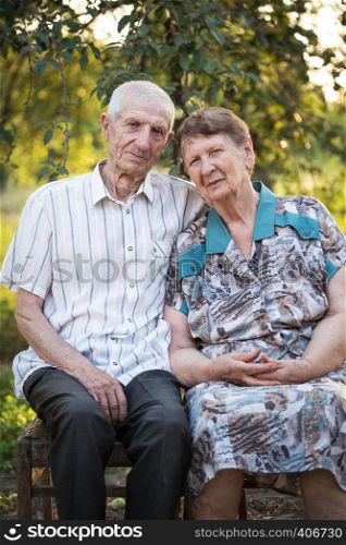 smiling grandparents. portrait of smiling senior man and senior woman at the garden. happy old age