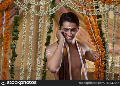 Smiling groom talking on cell phone