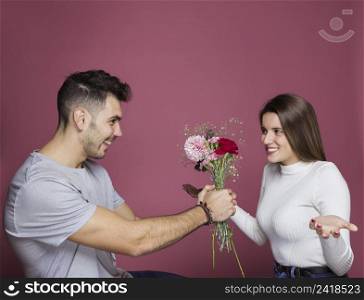 smiling guy presenting fresh flowers surprised attractive lady