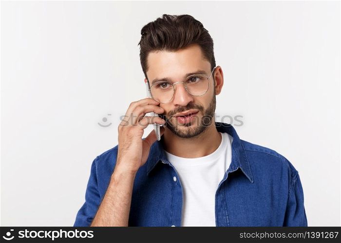 Smiling guy talking on a mobile phone isolated on white background. Smiling guy talking on a mobile phone isolated on white background.