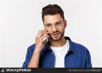 Smiling guy talking on a mobile phone isolated on white background. Smiling guy talking on a mobile phone isolated on white background.