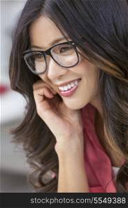 Smiling happy beautiful young Asian Chinese woman or girl wearing geek glasses