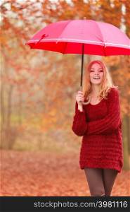Smiling happy fashion cute woman girl in maroon sweater with umbrella relaxing in fall autumn park. Happiness and relax in forest.. Fashion woman with umbrella relaxing in fall park.