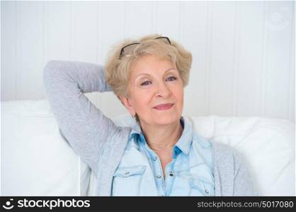 Smiling happy senior woman relaxing at home