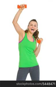 Smiling healthy young woman making exercise with dumbbells