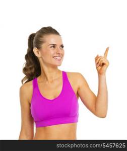 Smiling healthy young woman pointing on copy space