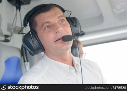smiling helicopter pilot with headset