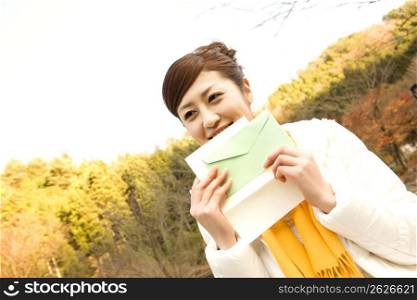 Smiling Japanese girl with a letter