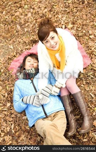 Smiling Japanese teenage couple in the woods