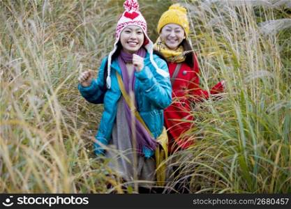 Smiling Japanese teenage girls in a field