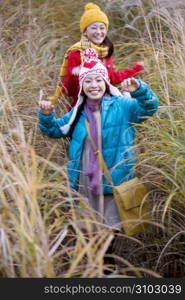 Smiling Japanese teenage girls in a field