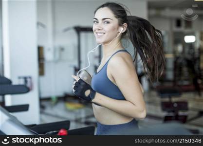 smiling jogging woman listening music