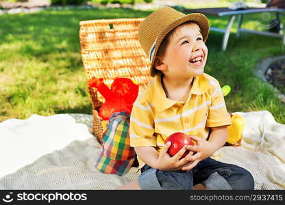 Smiling kid holding juicy apple