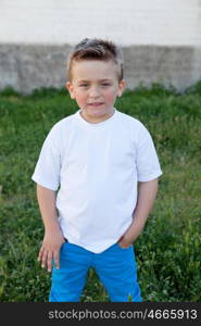 Smiling kid with blue eyes about 5 years in the garden