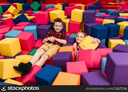 Smiling kids play in child entertainment center. Happy childhood
