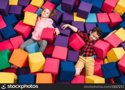 Smiling kids play in child entertainment center. Happy childhood. Kids play in child entertainment center