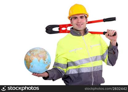 Smiling laborer holding a globe, studio shot