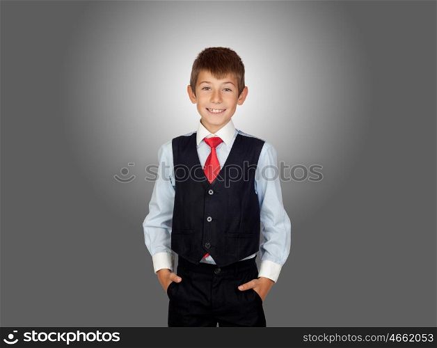 Smiling little businessman on a over gray background