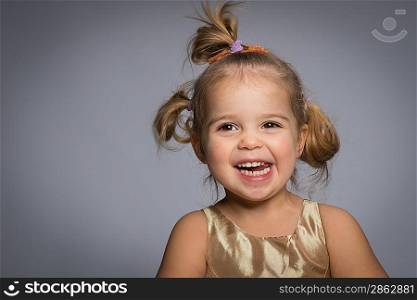 Smiling little girl isolated on grey