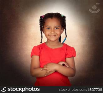 Smiling little girl with her crossed arms on a over brown background