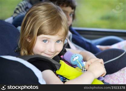 smiling little girl with safety belt on car security chair