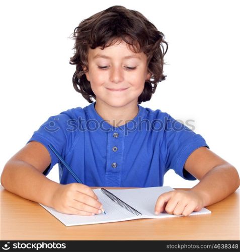 Smiling little student writing in the notebook isolated on a white background