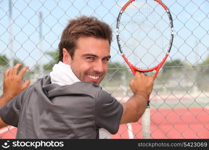 Smiling male tennis player