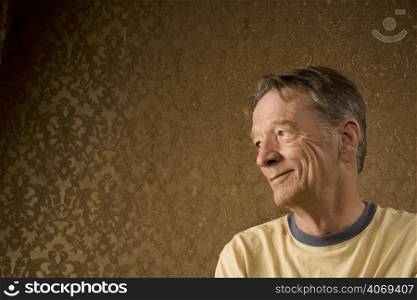 Smiling man against wallpaper