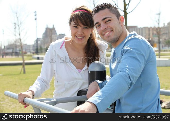 Smiling man and woman relaxing outdoors