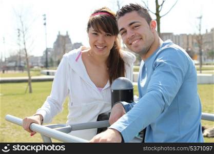 Smiling man and woman relaxing outdoors