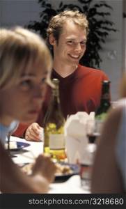 Smiling Man at Dinner Party