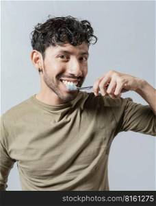 Smiling man brushing his teeth isolated, Face of handsome man brushing his teeth. Tooth brushing and care concept. Face of guy brushing teeth isolated. Oral and dental smile concept