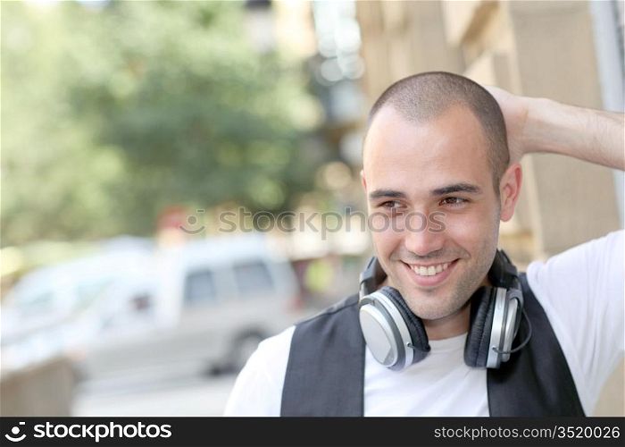 Smiling man listening to music in the street