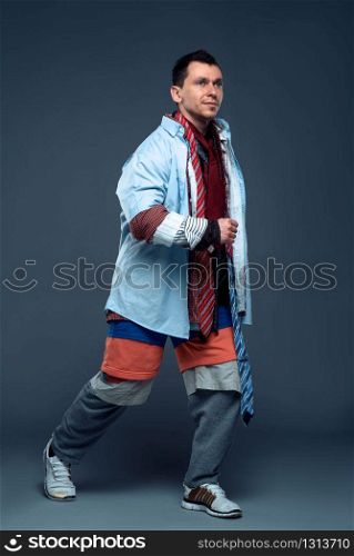 Smiling man runs on clothing sale. Shopping concept. Clothing store advertising