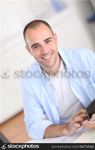 Smiling man sitting in office