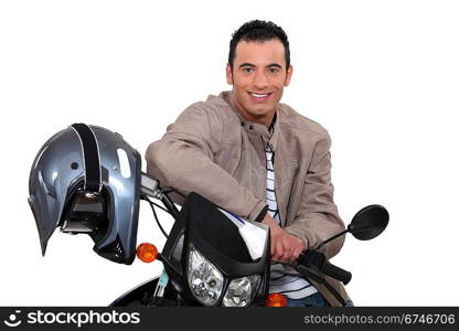 Smiling man sitting on a motorbike