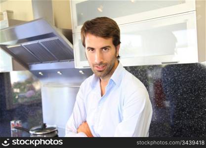 Smiling man standing in domestic kitchen