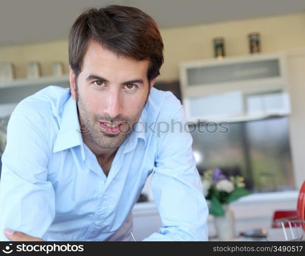 Smiling man standing in domestic kitchen