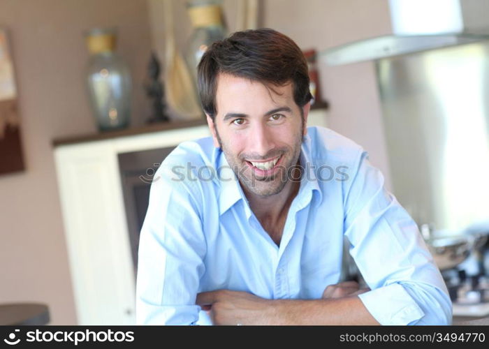 Smiling man standing in domestic kitchen