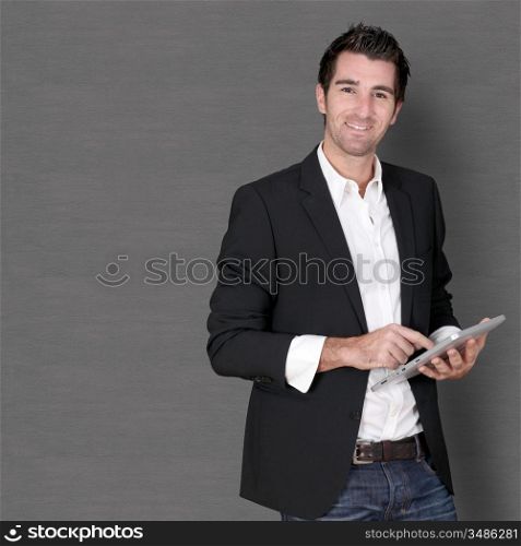 Smiling man standing on dark background