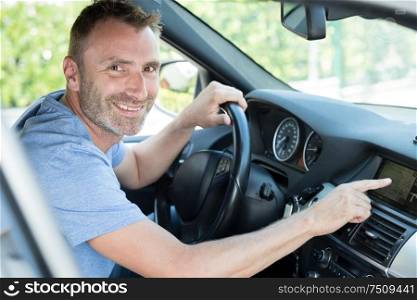 smiling man using a car gps