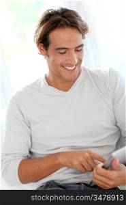 Smiling man using touchpad at home