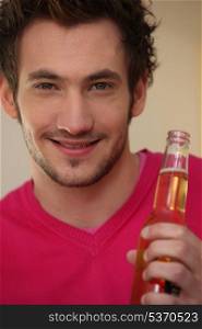 Smiling man with bottle of beer