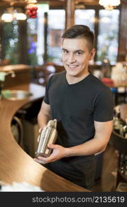 smiling man with cocktail shaker