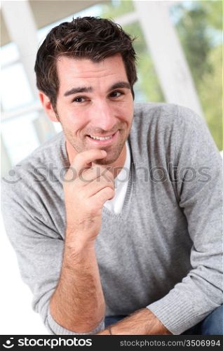 Smiling man with hand on chin