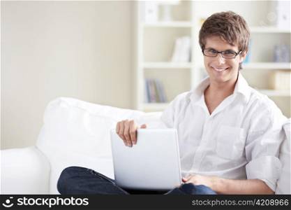 Smiling man with laptop at home