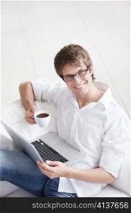 Smiling man working on his laptop