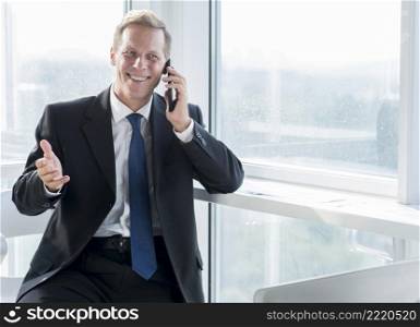 smiling mature businessman talking mobile phone