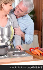 Smiling mature couple cooking